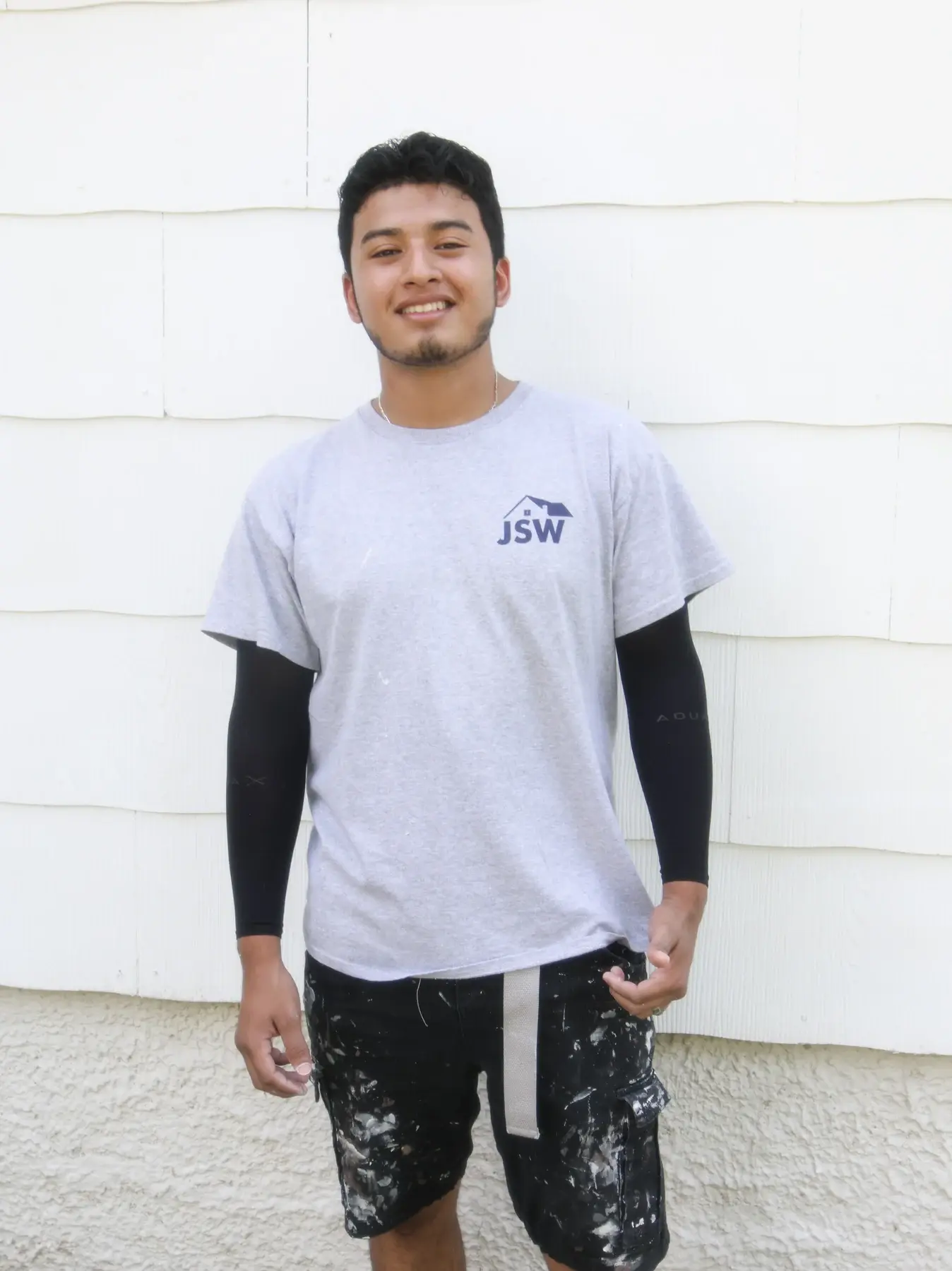 JSW crew member in a gray company shirt standing outdoors