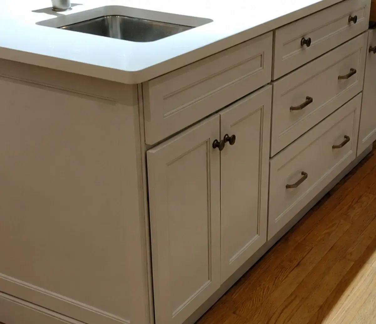 Painted kitchen island cabinetry with coordinated drawers and hardware