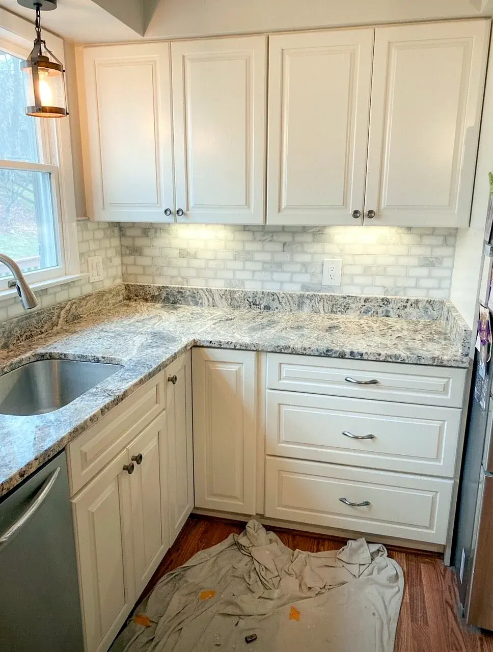 Cabinet painting preparation with the kitchen and flooring protected