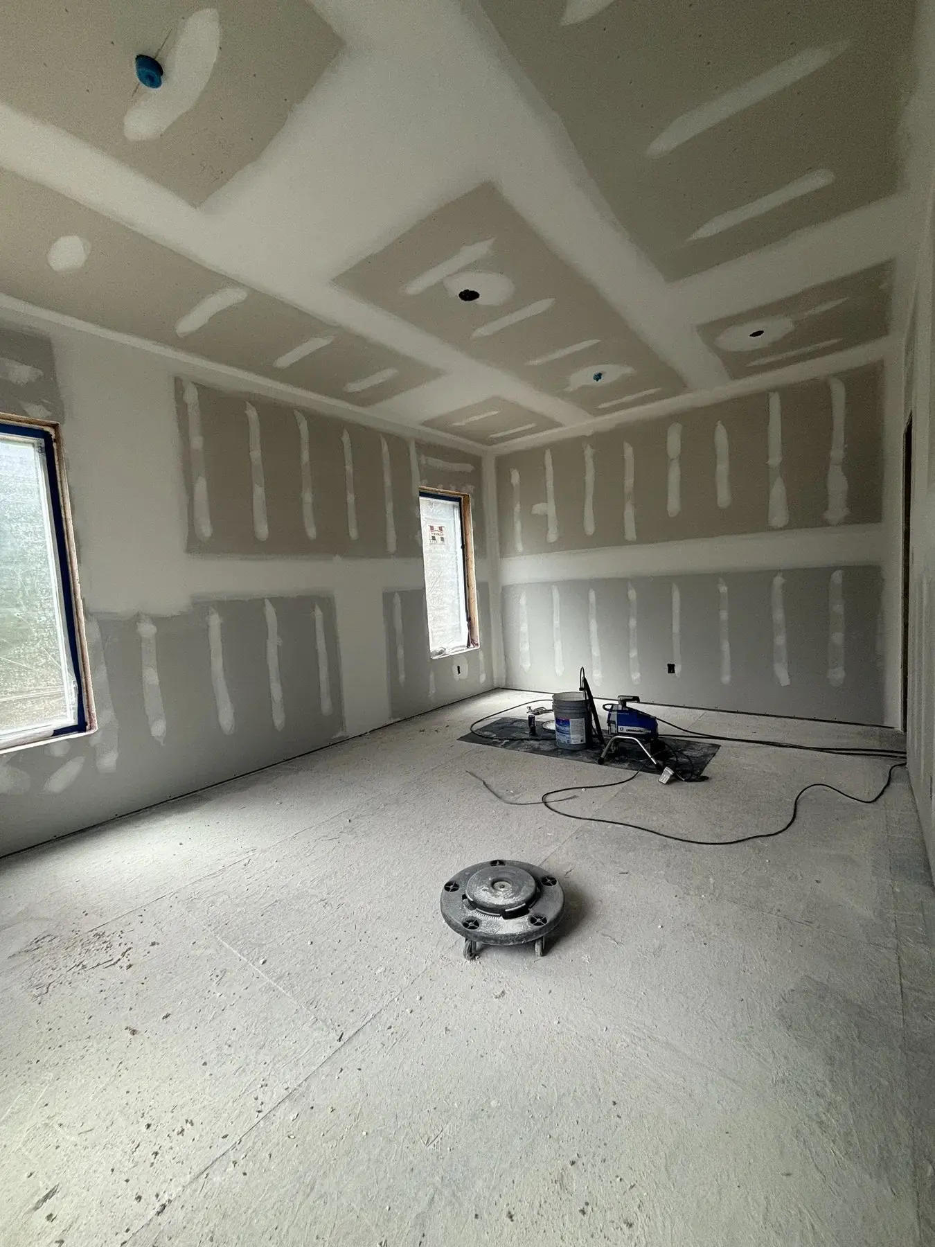 Drywall installation with taped seams and compound work in progress