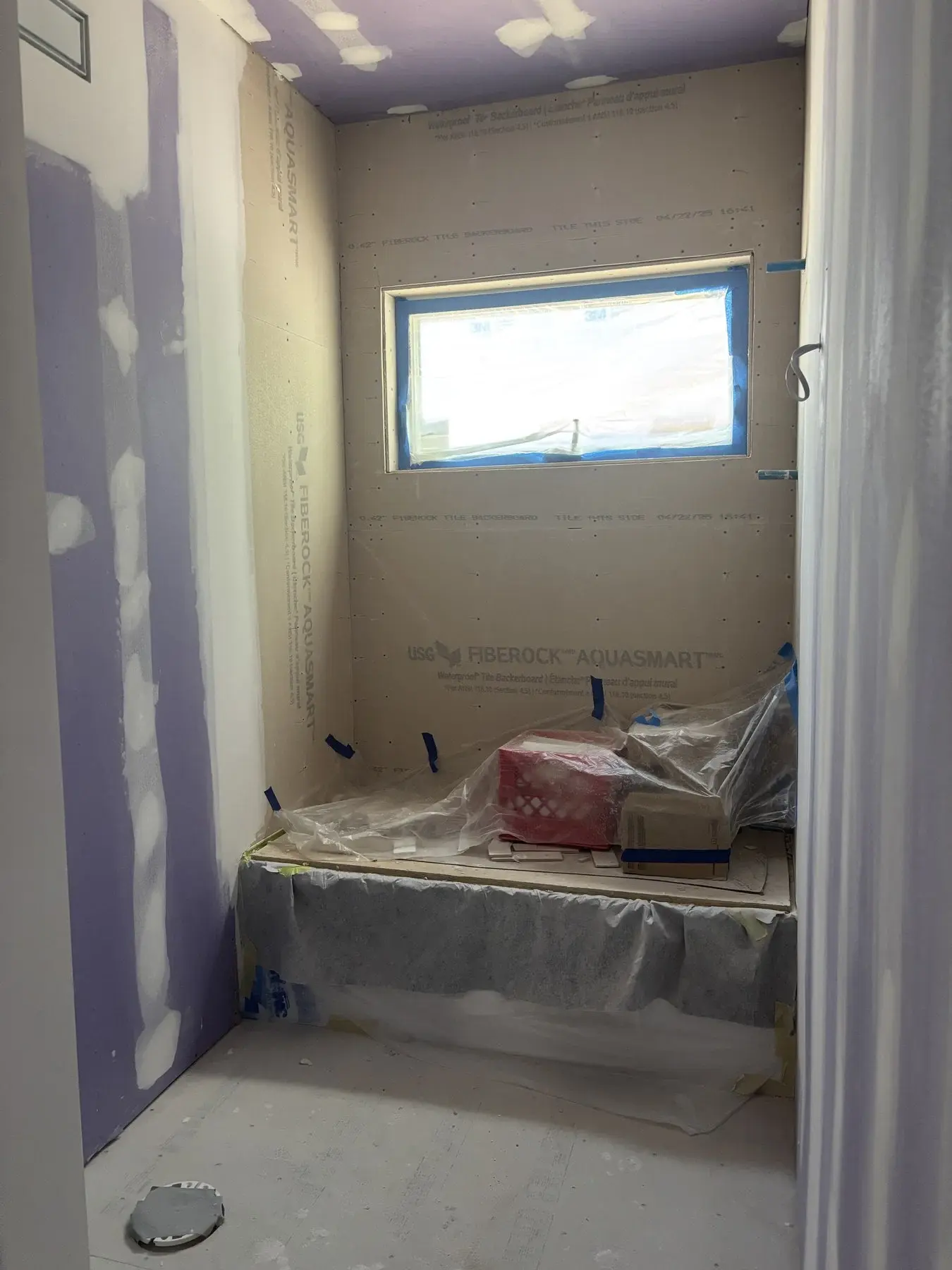 Open wall drywall installation showing new board placement and support areas