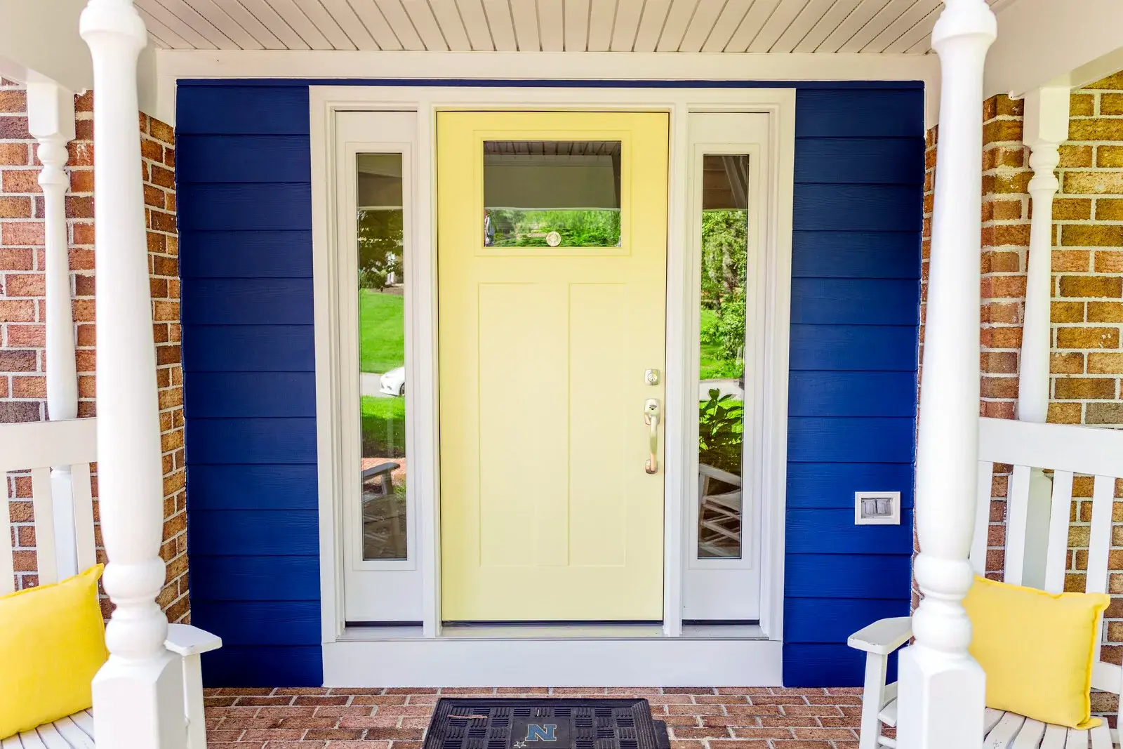 Blue exterior siding and a light front door with clean entry trim