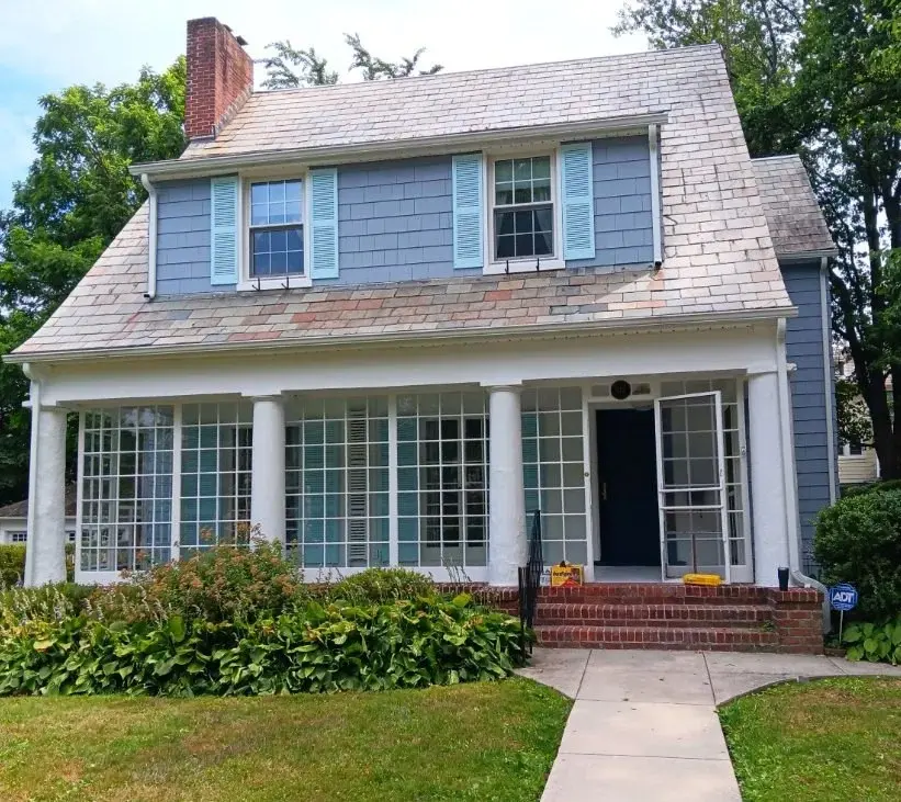 Finished blue-gray exterior with coordinated siding, shutters, trim, and entry details