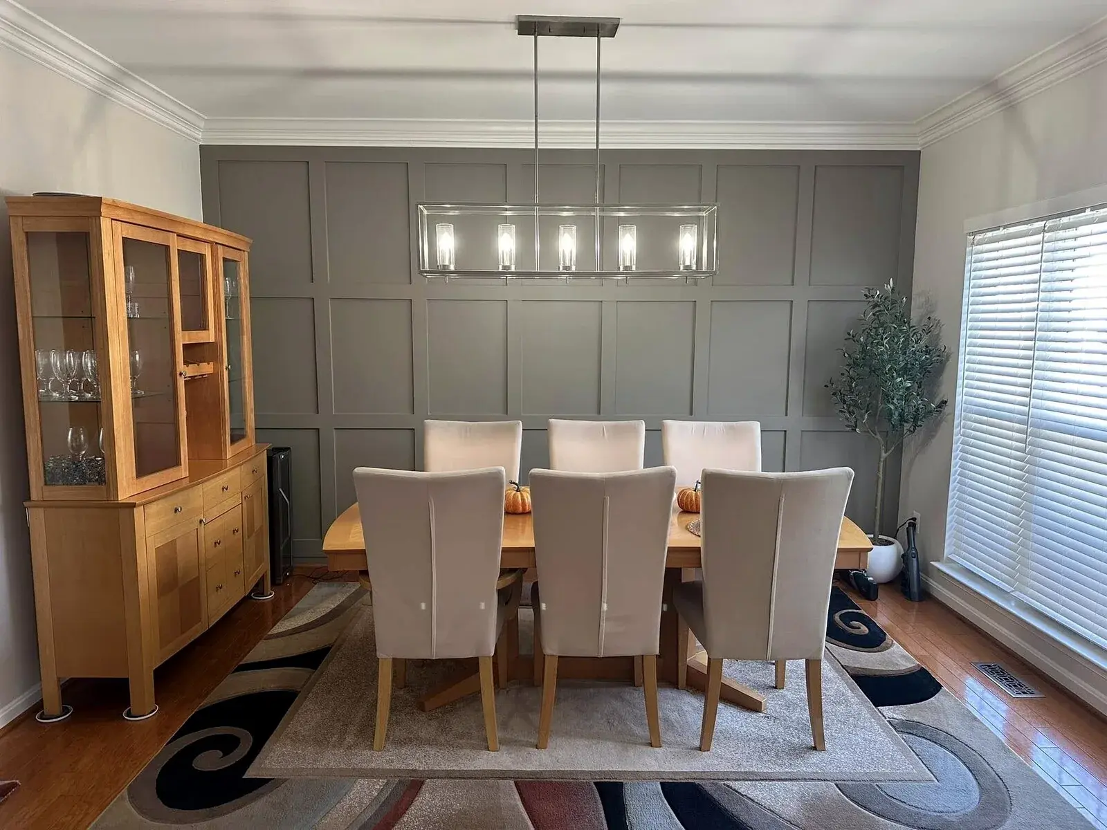 Finished dining room with measured painted wall paneling and balanced trim details