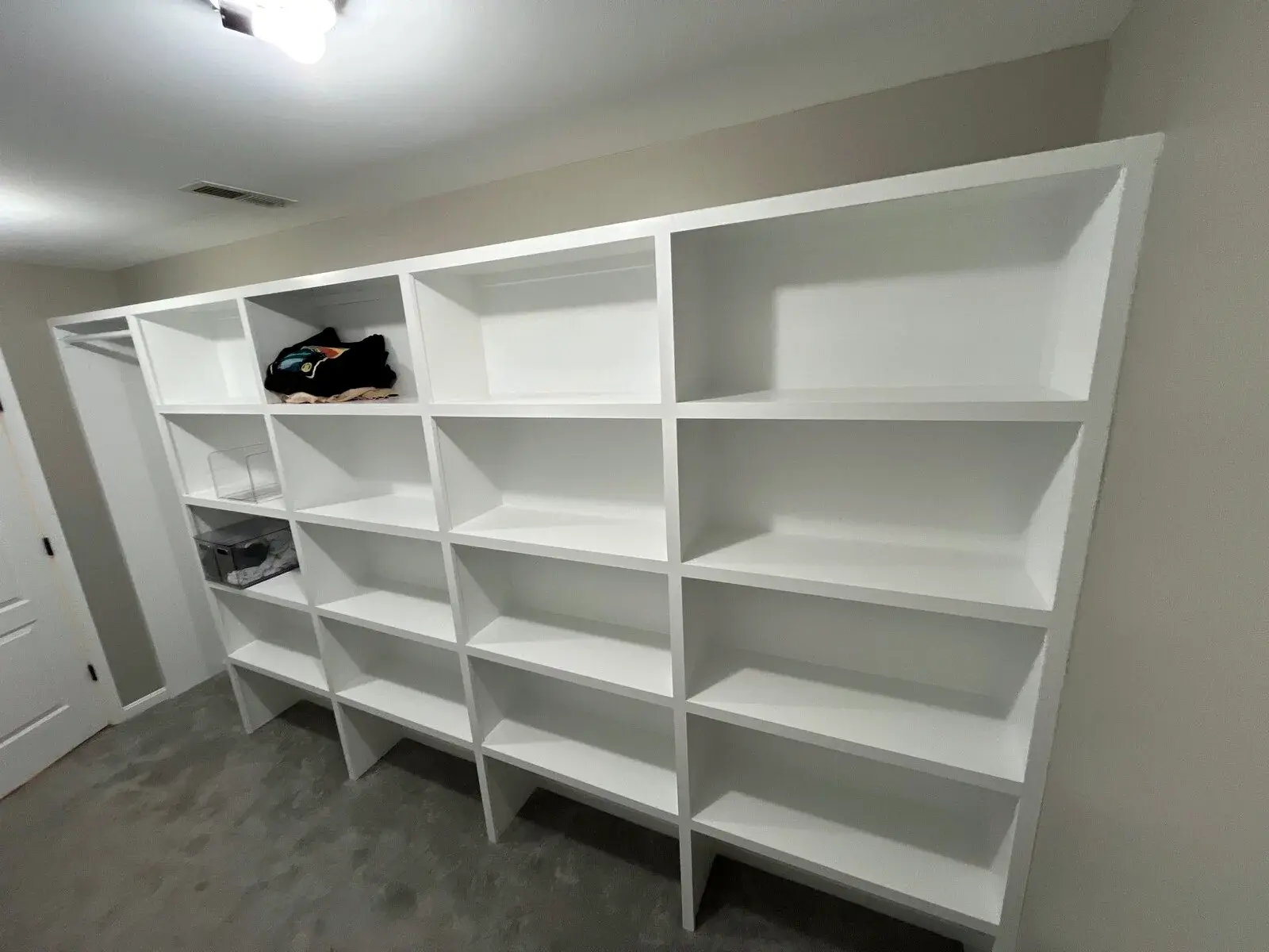 Full wall of finished built-in shelving showing fitted carpentry and clean edges