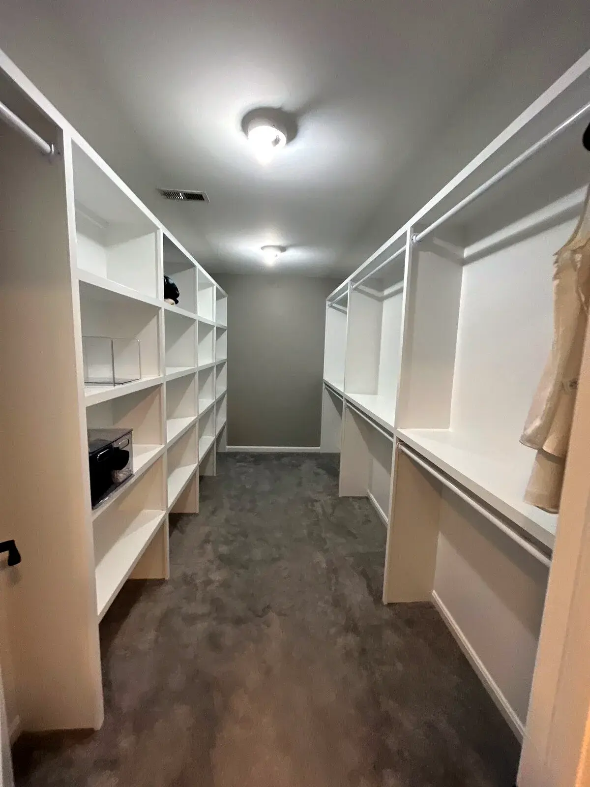 Walk-in closet with fitted built-in shelves and hanging storage