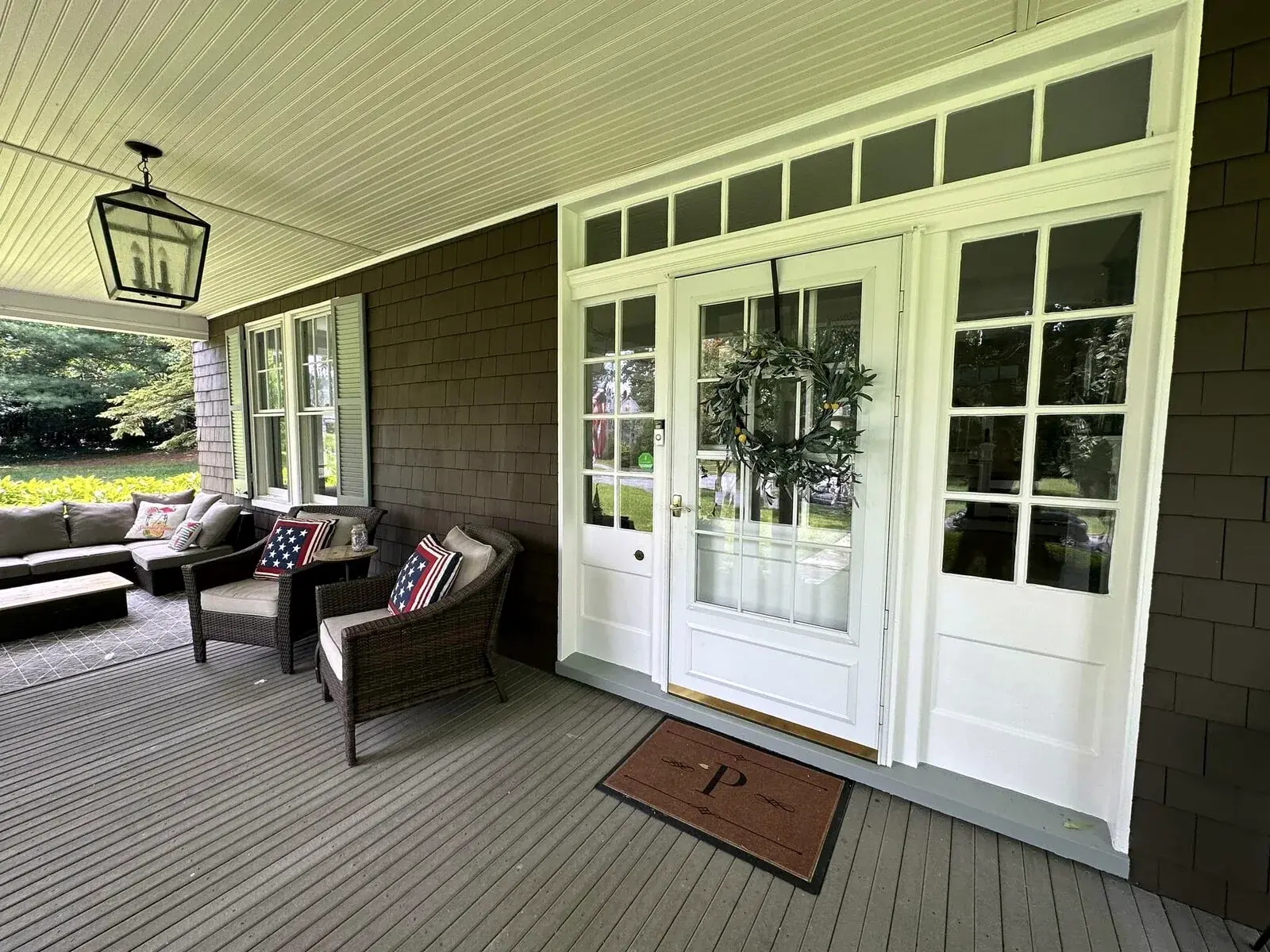 Finished covered porch with refreshed exterior trim and painted details