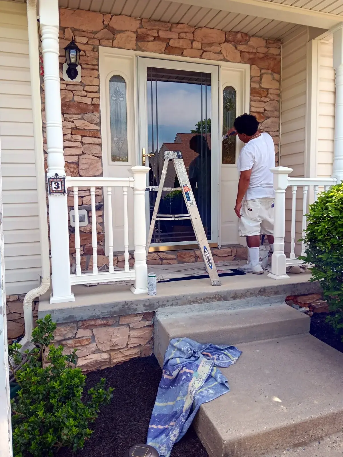 JSW painters working around an exterior entry door and trim