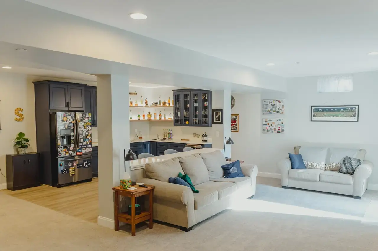 Finished JSW basement lounge with a built-in wet bar and open living area