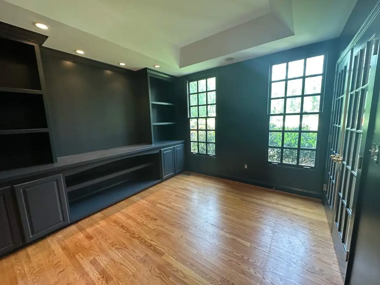 Finished dark built-in cabinetry and shelving with coordinated trim