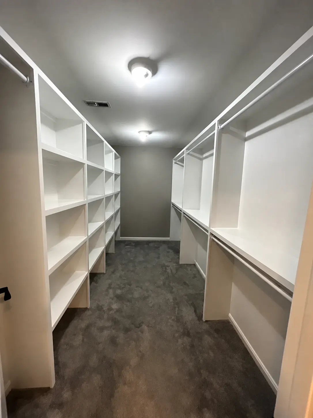 Walk-in closet with fitted built-in shelves and hanging storage