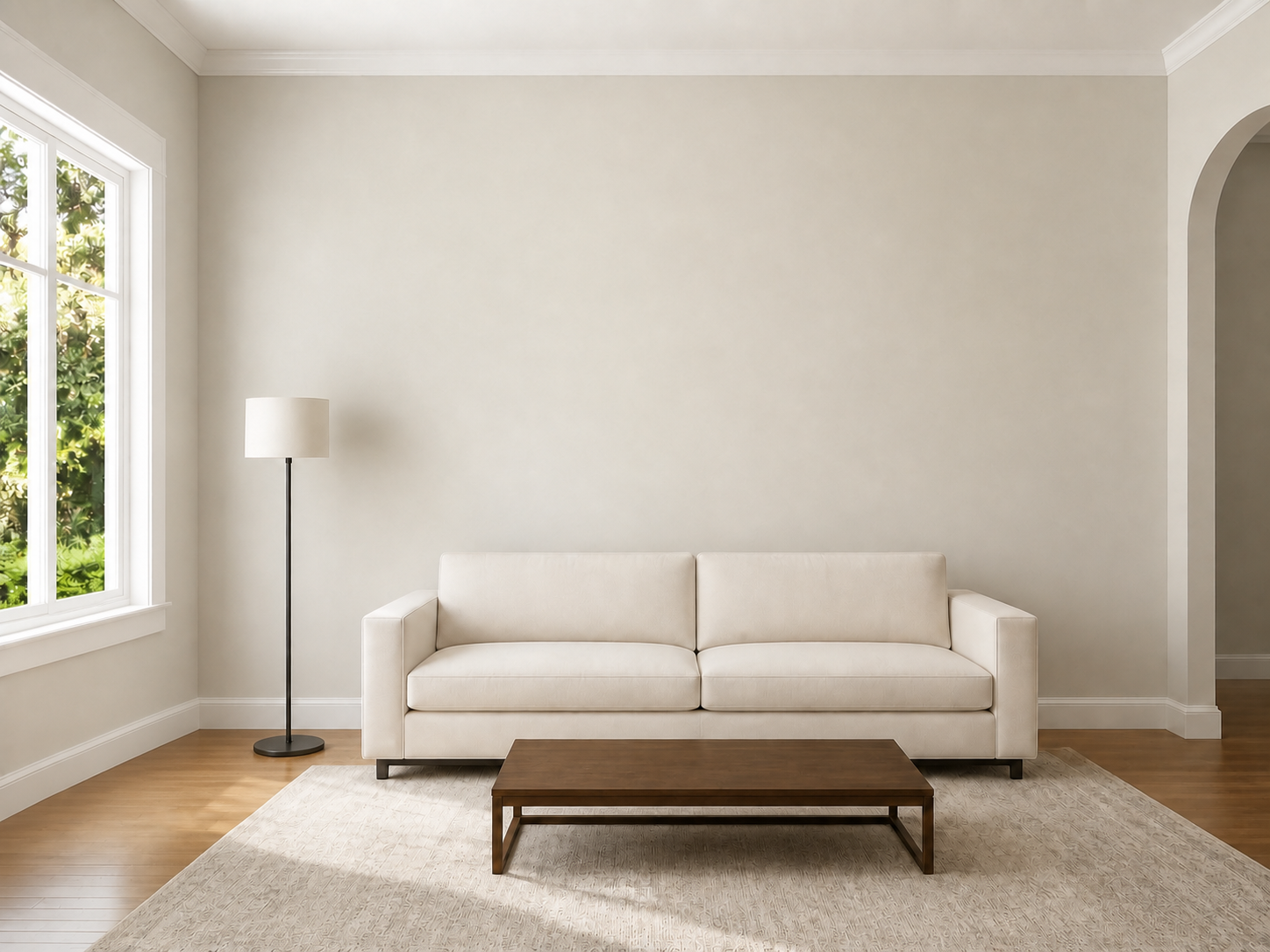 Simplified living room with a plain sofa, bare coffee table, and slim floor lamp used to preview wall colors