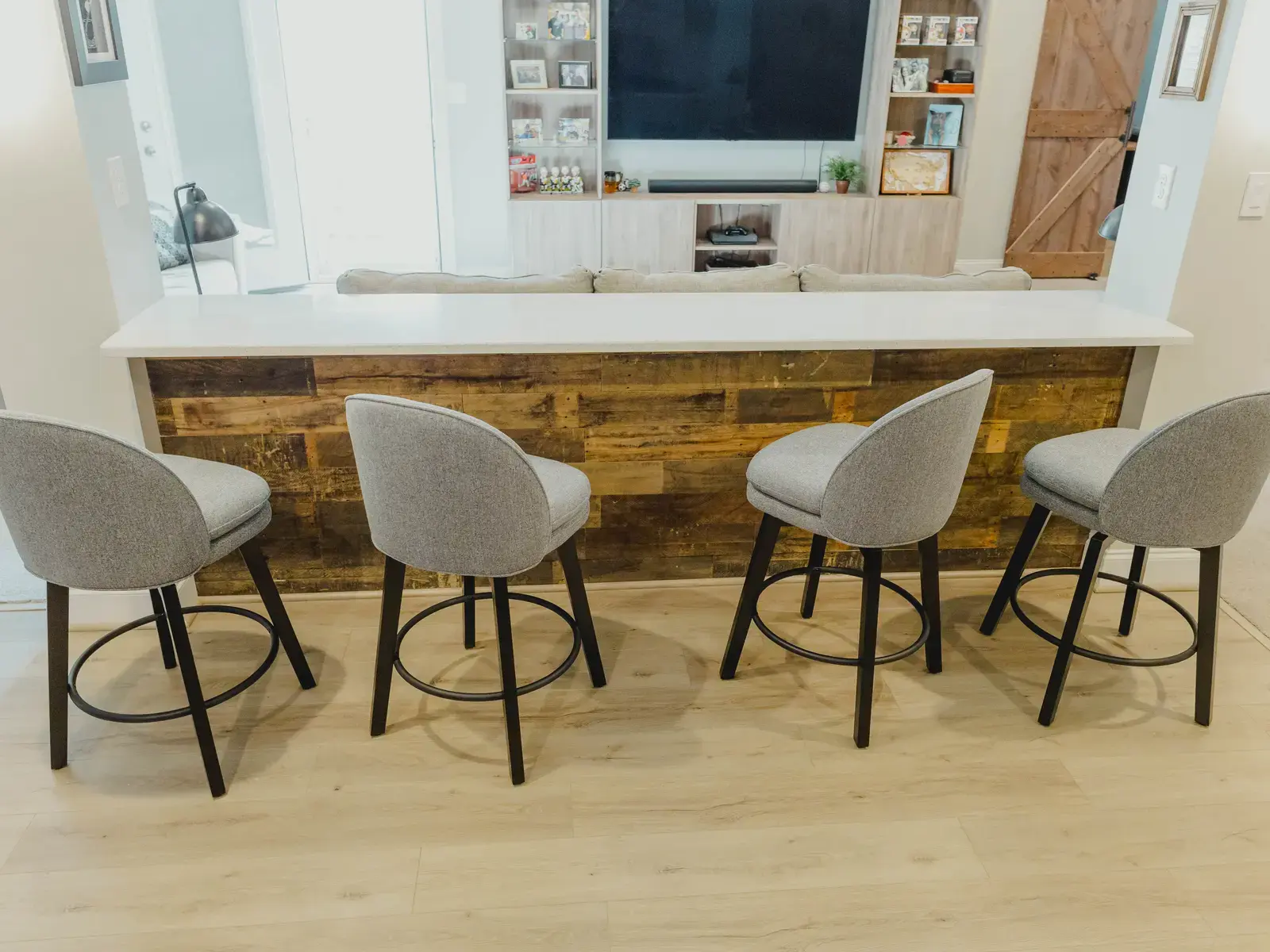 Finished basement bar counter with seating and coordinated wood facing