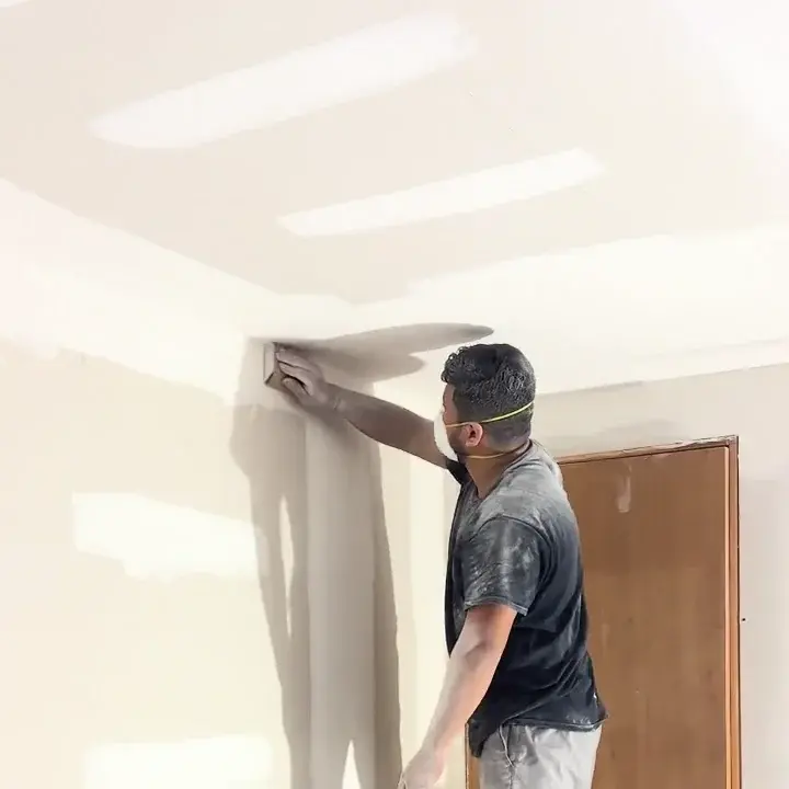Sanding the wall-to-ceiling corner
