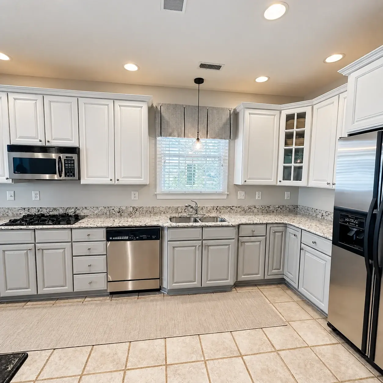 Finished kitchen with soft gray painted cabinetry, coordinated counters, and updated hardware