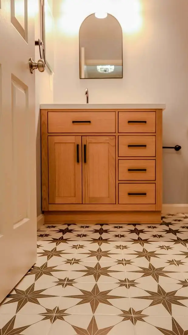 Finished bathroom with a freestanding tub, glass shower, vanity, and light tile