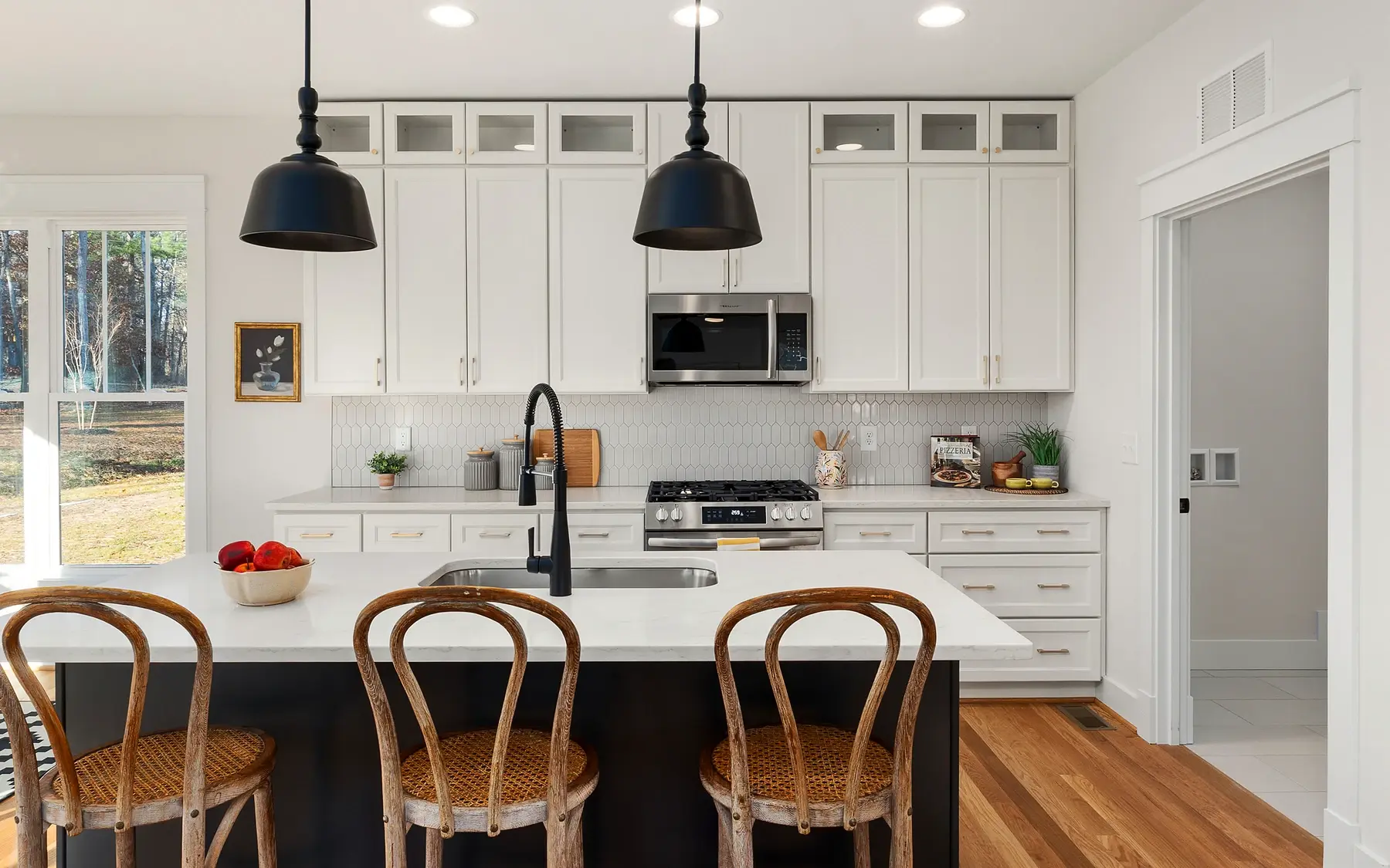 Finished painted kitchen with crisp cabinetry, a central island, and a polished room-wide finish