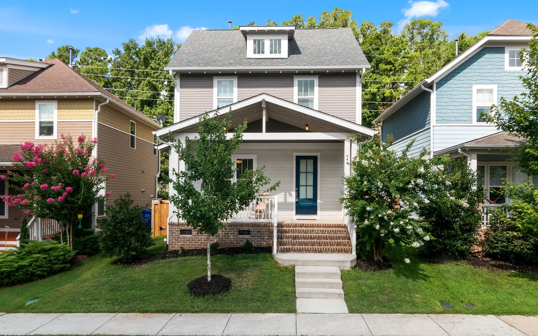 Finished exterior with refreshed siding, trim, shutters, and a polished front elevation